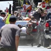 A vehicle drives into a group of protesters in Charlottesville, Va.
