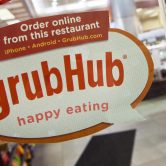Grubhub sign on a restaurant door.