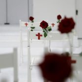 Roses decorate white church seats