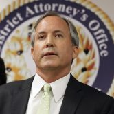 Ken Paxton speaks at a news conference.