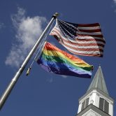 Rainbow flag below U.S. flag