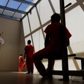 Immigrant detainees exercise at a detention facility.