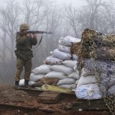 A Ukrainian soldier takes position on the front line