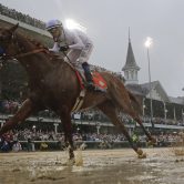 Mike Smith rides Justify to victory during the 144th running of the Kentucky Derby.