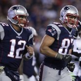 New England Patriots Tom Brady and Rob Gronkowski jog during a game.