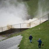 A photograph shows plumes coming off the Edenville Dam in Michigan