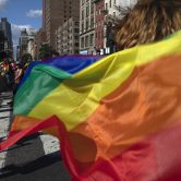 Parade-goers carry rainbow flags during an LBGTQ Pride march in New York.