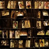 Photos of victims of the Rwanda genocide hang at a memorial center