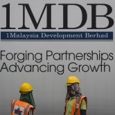 Construction workers chat in front of a billboard for 1MDB.