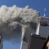 Smoke rises from the burning twin towers of the World Trade Center after hijacked planes crashed into them.