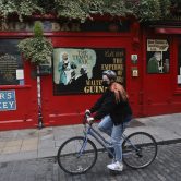 A cyclist rides past a bar in Dublin