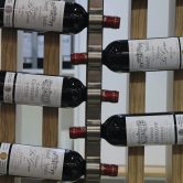 Red wine bottles of the region of Medoc, western France, are displayed at the wine fair in Paris.