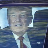 Donald Trump looks out his window as his motorcade drives through West Palm Beach, Fla.