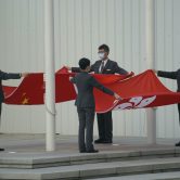 People fold the Chinese and Hong Kong flags.
