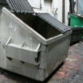 This photo shows a gray dumpster.