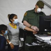 Migrants are processed at a holding facility in Texas