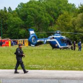 French gendarmes and firemen stand near helicopters in La Chapelle-sur-Erdre, France