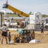Protestors demonstrate in front of pipeline construction