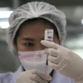 A health worker prepares shots of the AstraZeneca Covid-19 vaccine.