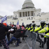 Supporters of then-President Donald Trump try to break through a police barrier at the U.S. Capitol.