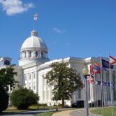 Flags fly outside the Alabama State Capitol building