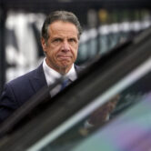 Andrew Cuomo prepares to board a helicopter after announcing his resignation.