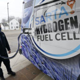Technician refills hydrogen fuel cell bus