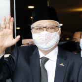 Ismail Sabri Yaakob waves to media as he departs to the national palace in Kuala Lumpur, Malaysia.