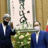 John Kerry gestures to Japanese Prime Minister Yoshihide Suga in Tokyo.