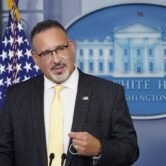 Miguel Cardona speaks during a press briefing at the White House.