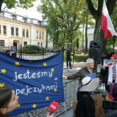 Polish activists stage a protest outside of the constitutional court.