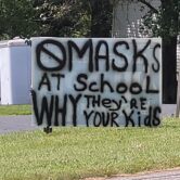 Signs highlighting the debate over mask mandates in schools.