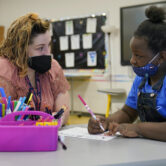 A teacher works one-on-one with a third grade student at Positive Tomorrows in Oklahoma City.