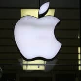 The Apple logo is illuminated at a store in Munich, Germany.