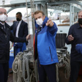 Charles Michel listens to Emmanuel Macron on a sailing ship.