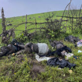 The dead bodies of unidentified people wearing military uniforms lie on the ground in Ethiopia.