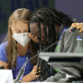 Ugandan climate activist Vanessa Nakate, right, is comforted by Swedish activist Greta Thunberg.