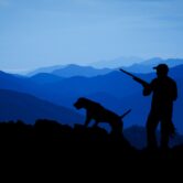 A hunter and hunting dog.