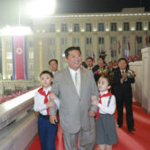 North Korean leader Kim Jong Un walks with children during a celebration of the nation’s 73rd anniversary.