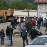 Local Serbs stand beside a road blocking the road leading to the northern Kosovo border crossing of Jarinje.