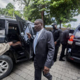 Haiti’s new Justice Minister Liszt Quitel leaves a courthouse after taking office.