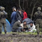 Polish security forces surround migrants along with border with Belarus