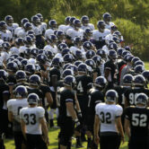 Northwestern football players gather during practice at the University of Wisconsin-Parkside campus.