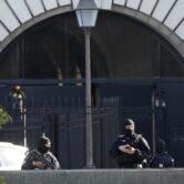 Security forces guard an entrance to the Palace of Justice in Paris