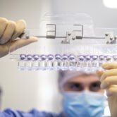 A technician inspects filled vials of the Pfizer-BioNTech Covid-19 vaccine.