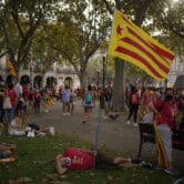 Pro-independence demonstrators rest after taking part in a demonstration in Barcelona.