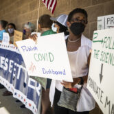 A woman demonstrates in favor of a mask mandate at a Texas school