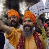 Sikh activists shout slogans against the Taliban and Pakistan to protest Taliban atrocities against Sikhs.