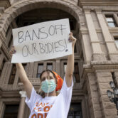 A woman participates in a protest against the six-week abortion ban at the Capitol in Austin, Texas.