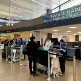 Travelers and workers at airport security